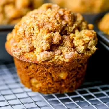 Freshly baked apple cinnamon muffins cooling on a rack