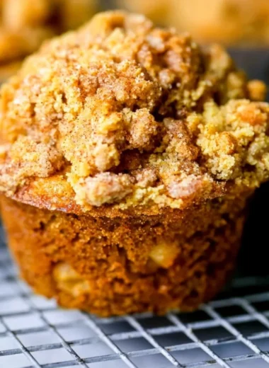 Freshly baked apple cinnamon muffins cooling on a rack