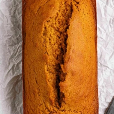 Slices of delicious homemade cake mix pumpkin bread on a wooden table