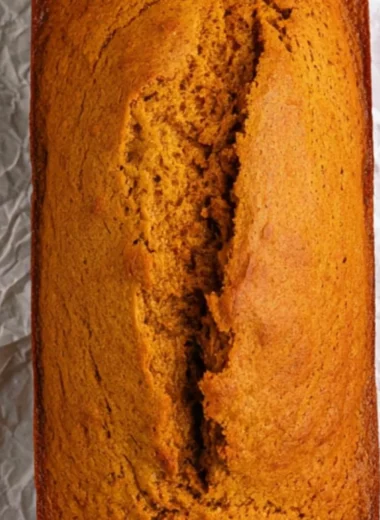 Slices of delicious homemade cake mix pumpkin bread on a wooden table