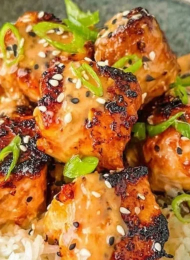 Cozy Bang Bang Salmon recipe served with vegetables on a plate