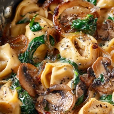 Cozy creamy tortellini with spinach, mushrooms, and caramelized onions dish