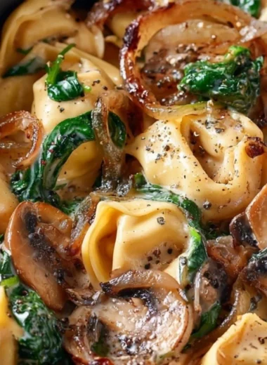 Cozy creamy tortellini with spinach, mushrooms, and caramelized onions dish