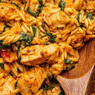 Delicious creamy Cajun Chicken Orzo served in a bowl with herbs