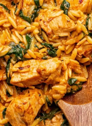 Delicious creamy Cajun Chicken Orzo served in a bowl with herbs
