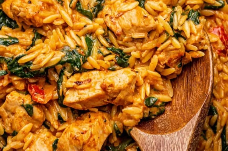 Delicious creamy Cajun Chicken Orzo served in a bowl with herbs