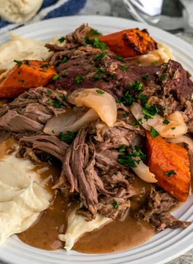 Crock Pot 3-Packet Pot Roast cooking in a slow cooker with spices and vegetables
