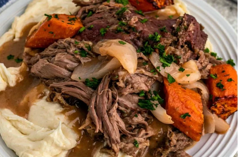 Crock Pot 3-Packet Pot Roast cooking in a slow cooker with spices and vegetables