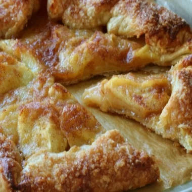 Delicious rustic French apple tart with golden crust and sliced apples