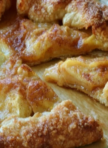 Delicious rustic French apple tart with golden crust and sliced apples