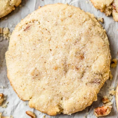 Delicious Pecan Sandies cookies with toasted pecans on a plate.