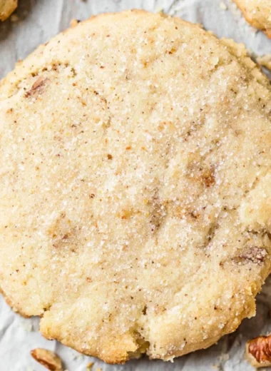 Delicious Pecan Sandies cookies with toasted pecans on a plate.