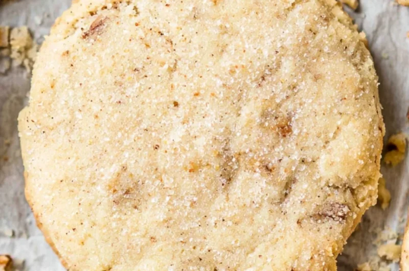 Delicious Pecan Sandies cookies with toasted pecans on a plate.