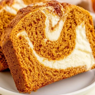 Delicious slice of pumpkin bread topped with cream cheese frosting.