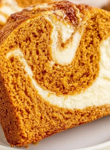 Delicious slice of pumpkin bread topped with cream cheese frosting.