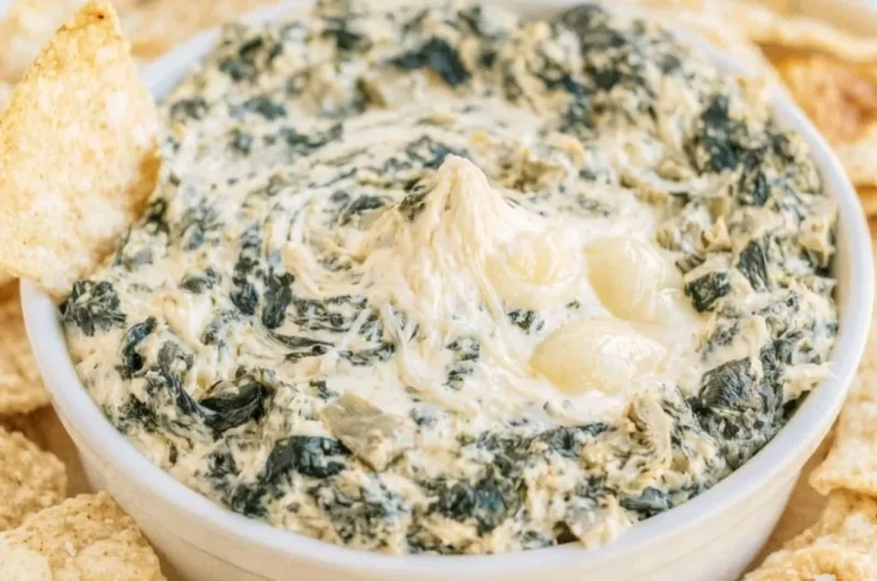Creamy slow cooker spinach artichoke dip served with tortilla chips