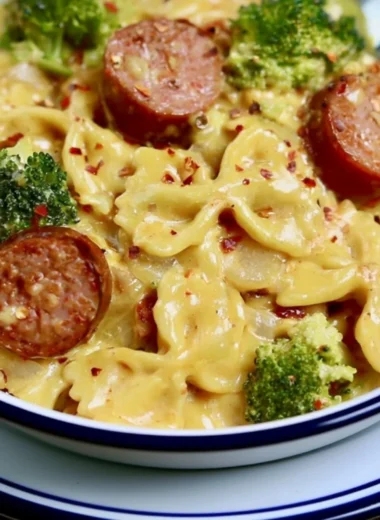Delicious Smoked Sausage Cheddar Pasta served in a bowl with fresh herbs.