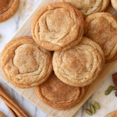 Chai snickerdoodles baked on a cooling rack, showcasing their cinnamon sugar coating.