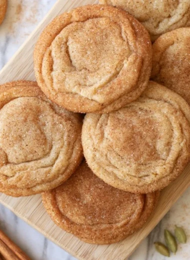 Chai snickerdoodles baked on a cooling rack, showcasing their cinnamon sugar coating.