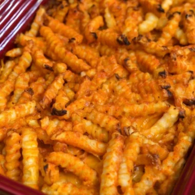 Cheeseburger Casserole topped with French fries in a baking dish