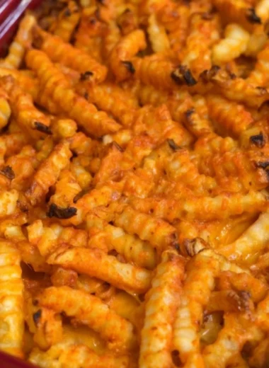 Cheeseburger Casserole topped with French fries in a baking dish