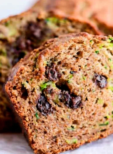 Loaf of chocolate chip zucchini bread on a wooden table