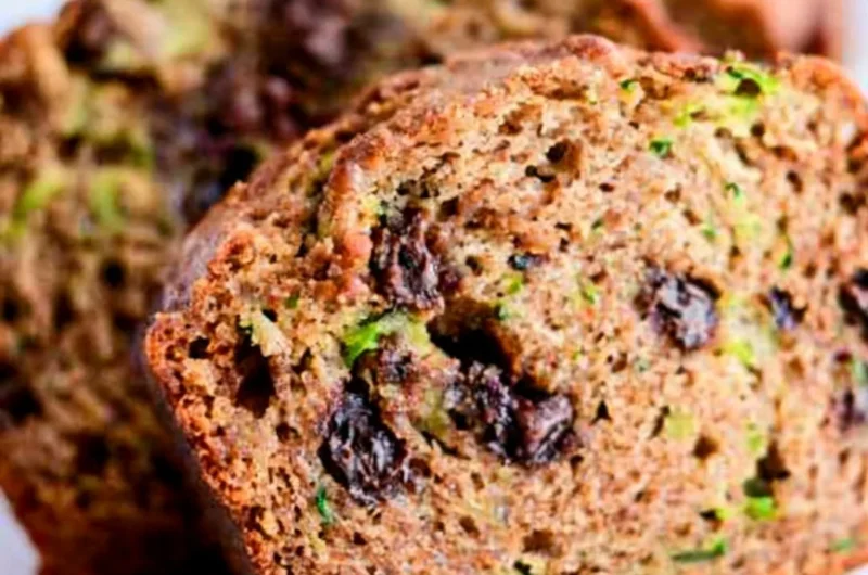 Loaf of chocolate chip zucchini bread on a wooden table