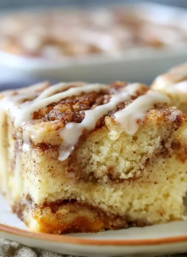 Delicious cinnamon roll cake with swirls of cinnamon and icing.