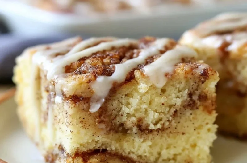 Delicious cinnamon roll cake with swirls of cinnamon and icing.