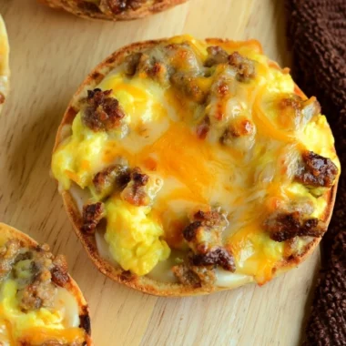 Delicious English Muffin Breakfast Pizza topped with cheese and eggs