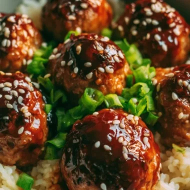 Delicious Asian meatballs garnished with herbs and served in a savory sauce.