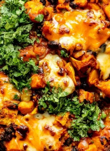 Butternut squash and black bean enchilada skillet topped with fresh ingredients