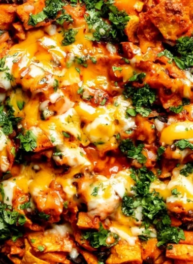 Butternut squash and black bean enchilada skillet topped with fresh ingredients.