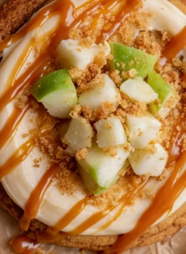 Crumbl caramel apple cookies featuring apple chunks and caramel drizzle