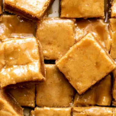 Delicious maple blondies topped with a rich maple glaze, ideal for dessert.