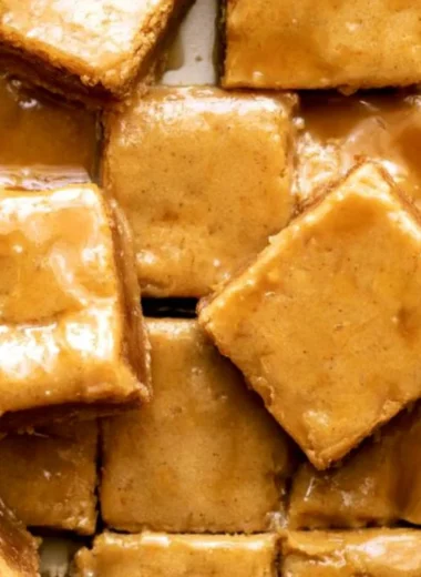 Delicious maple blondies topped with a rich maple glaze, ideal for dessert.