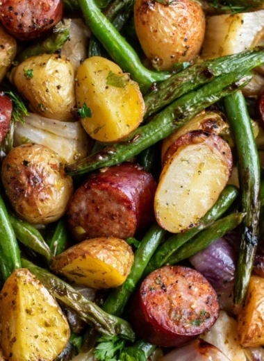 One Pan Sausage with green beans and potatoes on a serving plate.