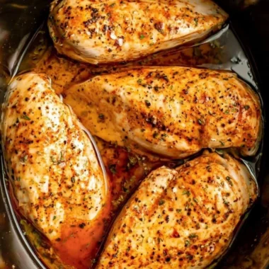 Tender slow cooker chicken breasts in a savory sauce