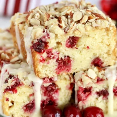 Delicious cranberry almond cake decorated with fresh cranberries and almonds.