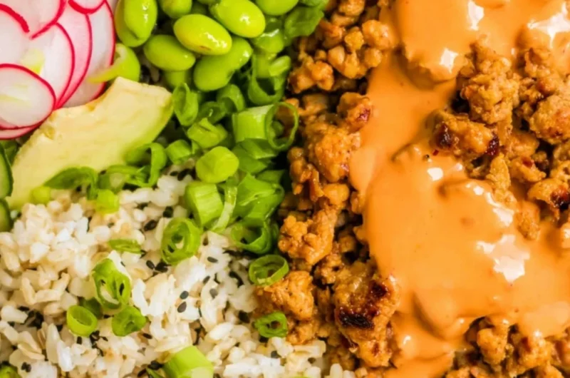A flavorful bowl of Bang Bang Ground Turkey Rice Bowls garnished with vegetables.