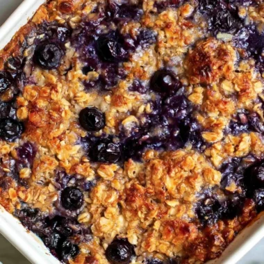Delicious blueberry baked oatmeal topped with fresh blueberries and nuts