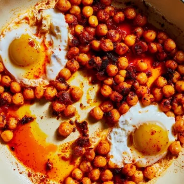 Delicious chickpea fried eggs served on a plate with fresh herbs