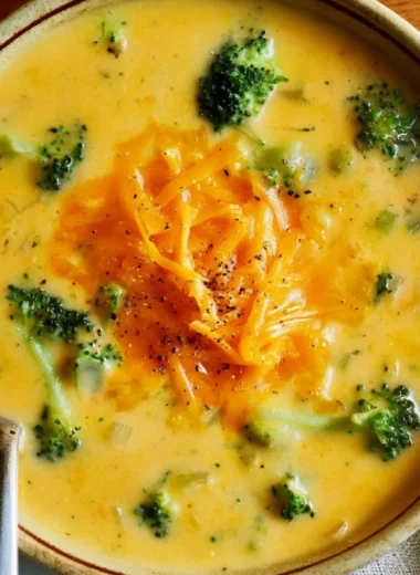 Delicious bowl of easy broccoli cheddar soup garnished with cheddar cheese