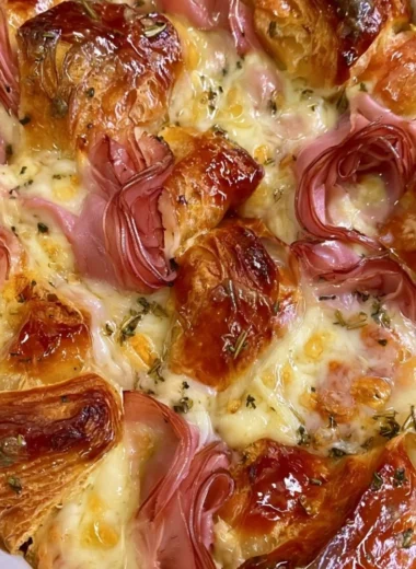 Delicious croissant bake casserole served on a plate for a hearty breakfast or dinner.
