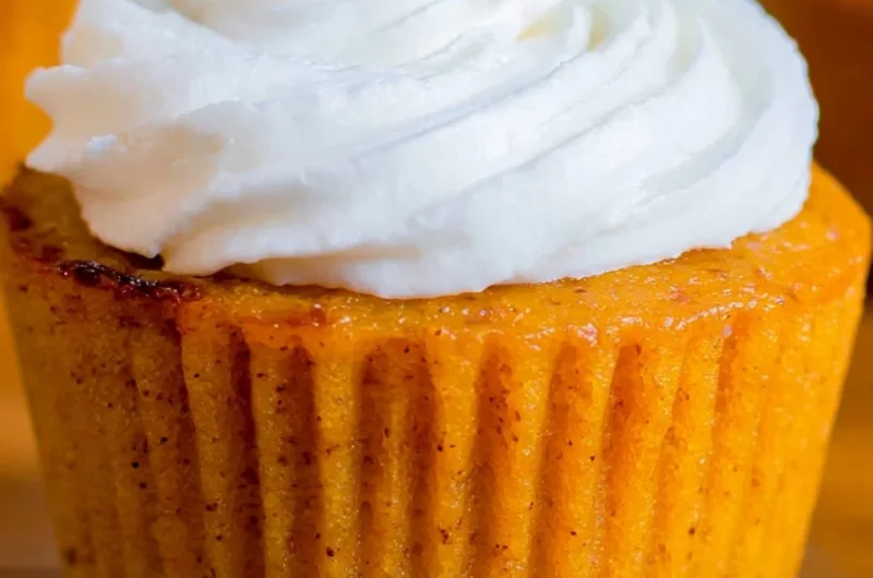 Delicious Impossible Pumpkin Pie Cupcakes topped with whipped cream