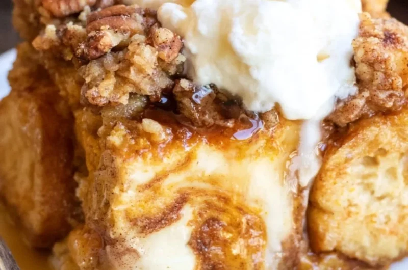 Delicious Pumpkin French Toast Casserole topped with syrup and whipped cream.