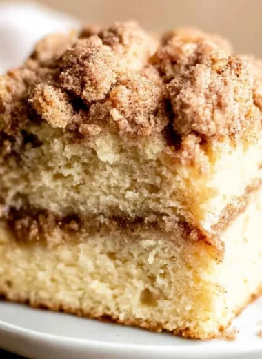 Sour cream coffee cake topped with cinnamon swirl and crumble