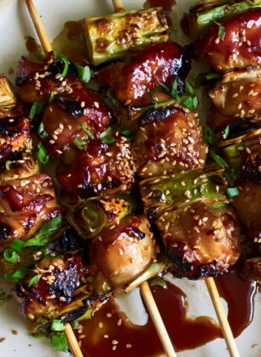 Delicious teriyaki chicken on a stick with marinade and sesame seeds