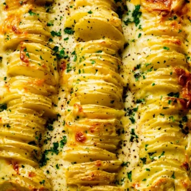 Deliciously baked scalloped potatoes with creamy cheese and layers of flavor.