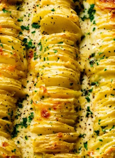 Deliciously baked scalloped potatoes with creamy cheese and layers of flavor.